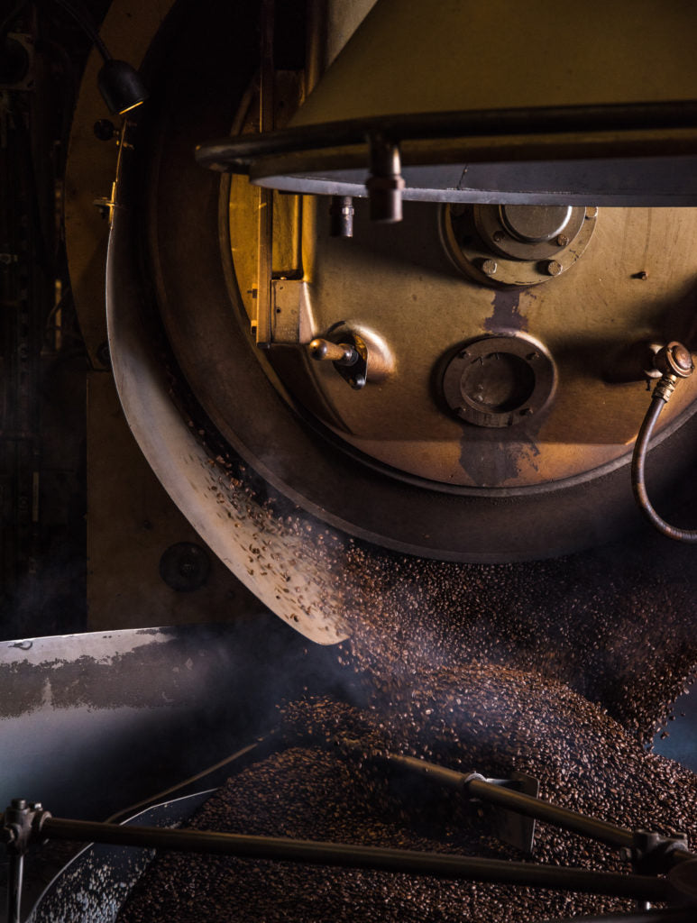a large coffee roasting machine with brown beans
